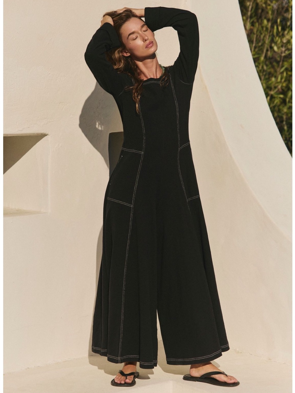 Free People "Strada Jumpsuit" in black featuring a contrast stitch detail. NWT